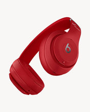 Load image into Gallery viewer, Red over-ear wireless Bluetooth headphones with the Beats logo on the ear cup.