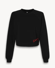 Load image into Gallery viewer, A black mid-length fleece pullover for women, featuring a small red design on the lower left side.